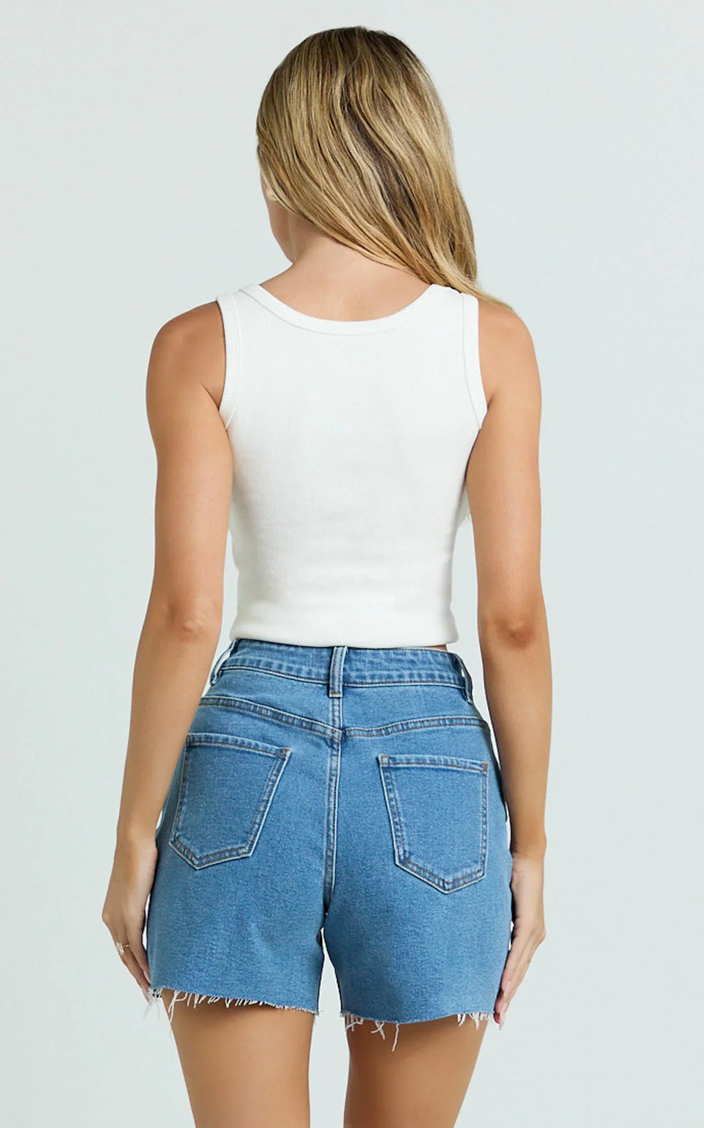 Jacqui Shorts - Mid Rise Frayed Hem Denim Shorts in Light Mid Blue